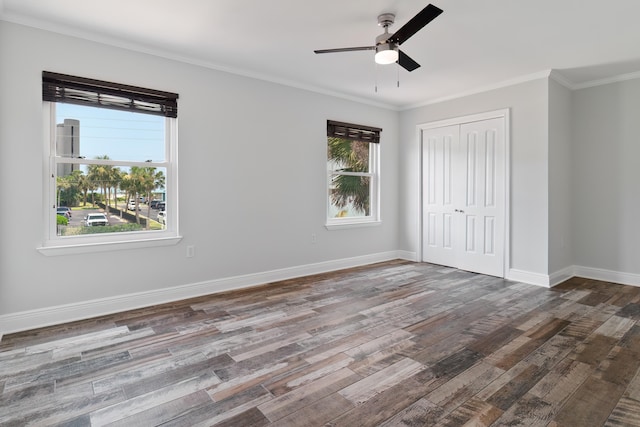 spare room featuring ornamental molding, ceiling fan, plenty of natural light, and dark wood-type flooring