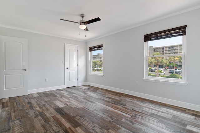 spare room with dark hardwood / wood-style flooring, ceiling fan, and crown molding