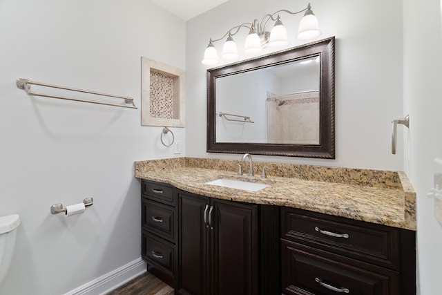 bathroom with hardwood / wood-style floors, toilet, and vanity