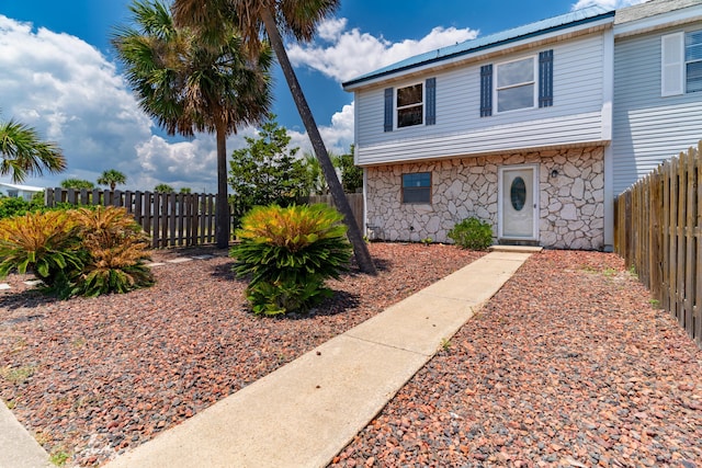 356 Billfish Ave Unit 8, Fort Walton Beach, FL 32548 - view of front facade with metal roof, fence private yard, and stone siding