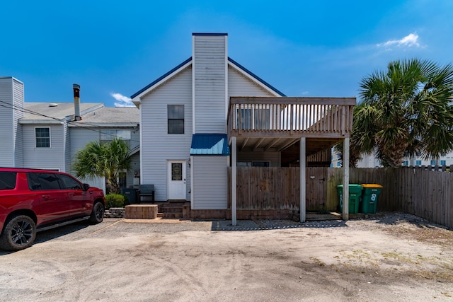 356 Billfish Ave Unit 8, Fort Walton Beach, FL 32548 - back of property featuring a chimney and fence