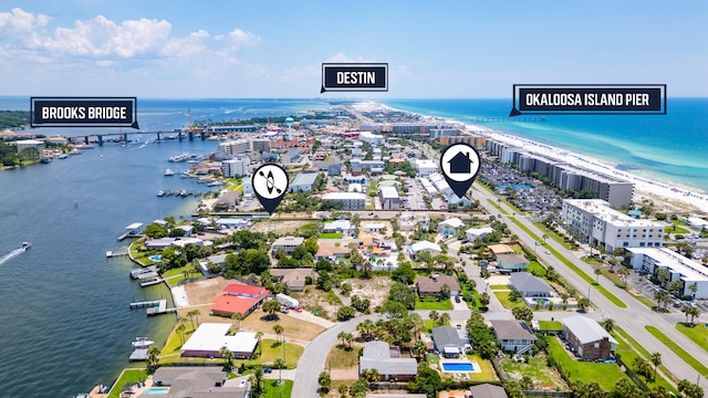 drone / aerial view featuring a water view and a view of the beach