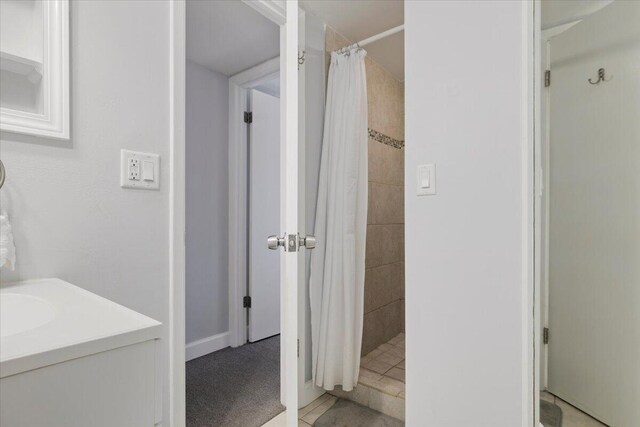 bathroom featuring tile patterned floors and curtained shower