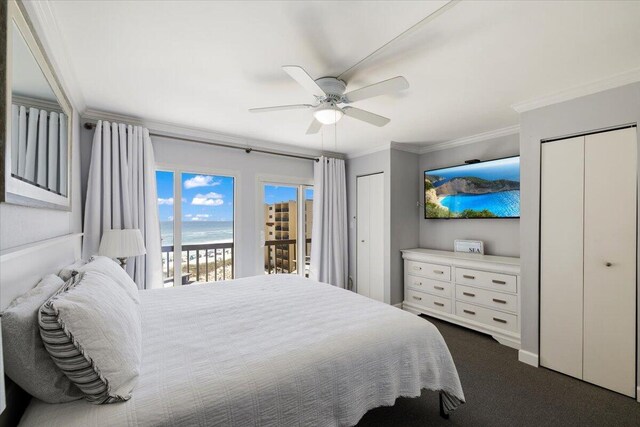 bedroom with crown molding, dark colored carpet, access to exterior, ceiling fan, and two closets