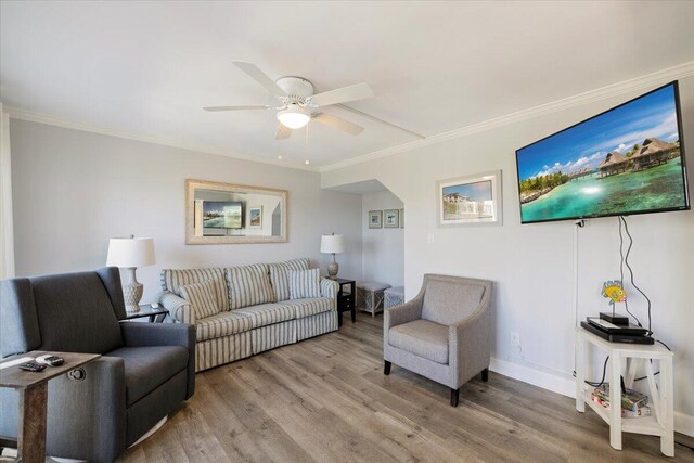 living room with crown molding, hardwood / wood-style floors, and ceiling fan