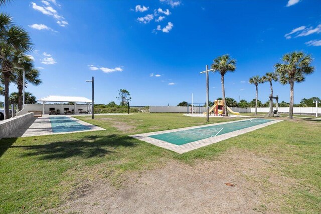 view of property's community with a playground and a lawn