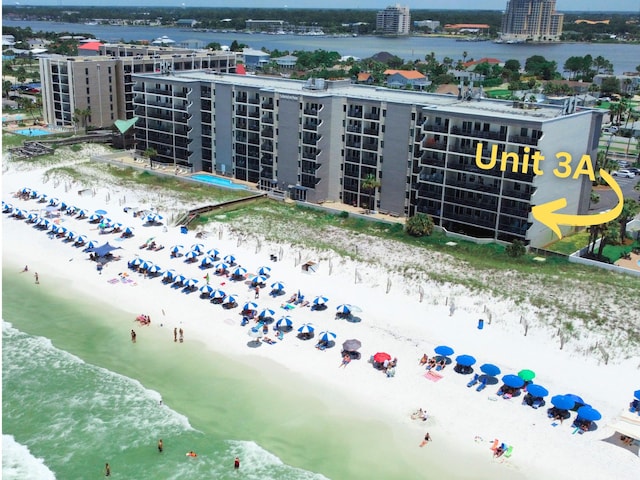 bird's eye view featuring a water view, a city view, and a view of the beach