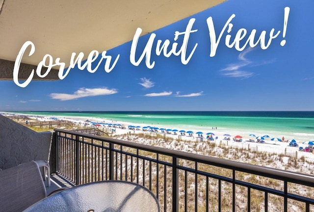 balcony featuring a water view and a beach view