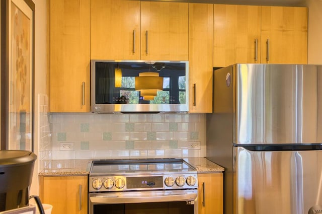 kitchen with tasteful backsplash, light stone countertops, and stainless steel appliances