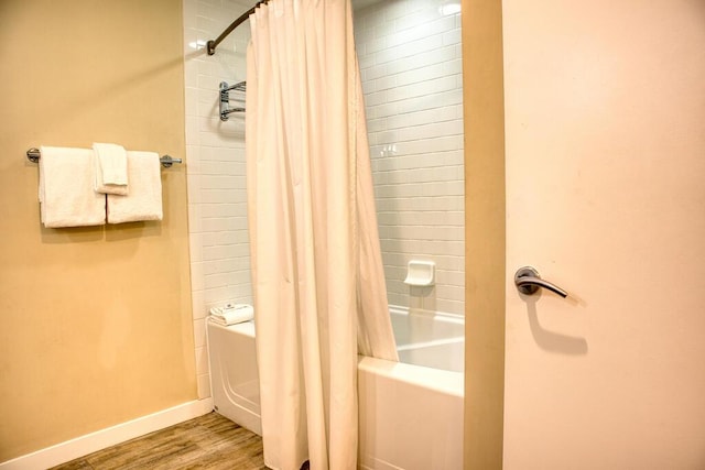 bathroom with wood-type flooring and shower / bath combination with curtain