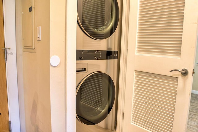 washroom featuring stacked washer / dryer