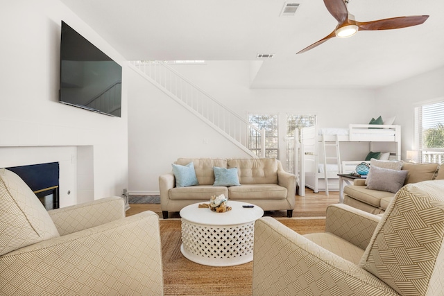 living room with hardwood / wood-style floors and ceiling fan