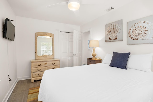 bedroom featuring hardwood / wood-style flooring, a closet, and ceiling fan