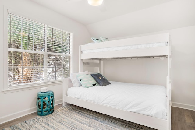 bedroom with ceiling fan, lofted ceiling, and hardwood / wood-style flooring