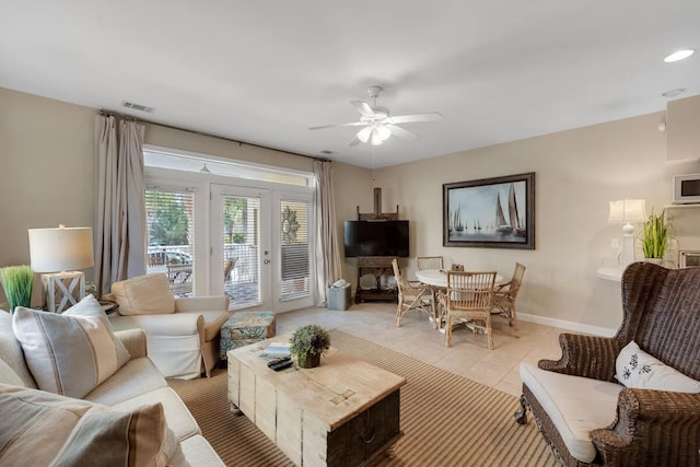 living room with light tile patterned floors, french doors, and ceiling fan