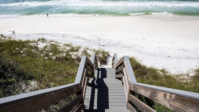 surrounding community with a view of the beach and a water view