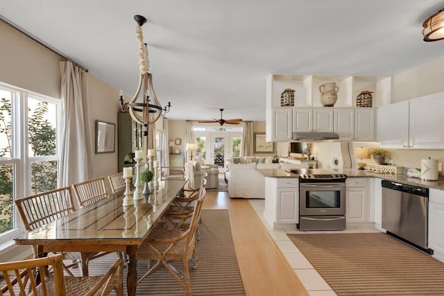 kitchen with white cabinets, appliances with stainless steel finishes, and french doors