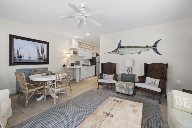 tiled living room with ceiling fan