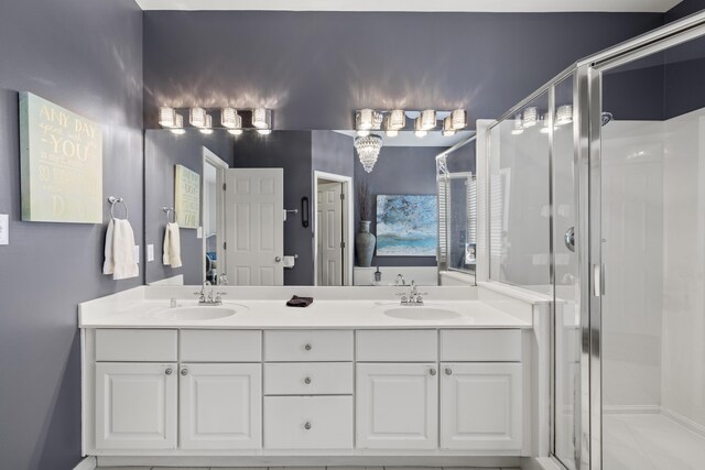 bathroom featuring vanity and a shower with shower door