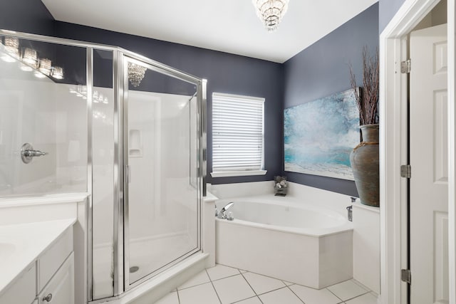 bathroom with tile patterned flooring, vanity, and independent shower and bath