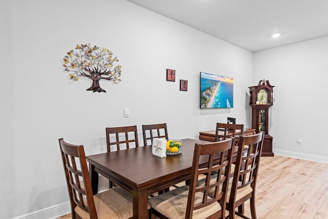 dining space with light hardwood / wood-style floors