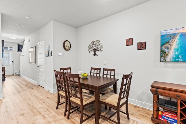 dining space with light hardwood / wood-style flooring