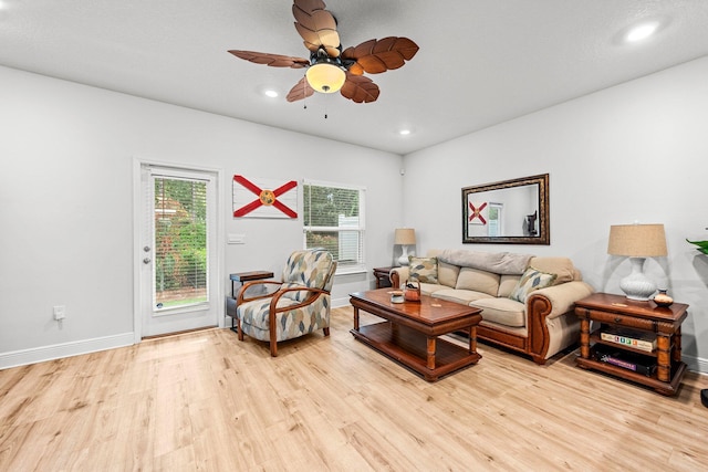 living room with ceiling fan and light hardwood / wood-style floors