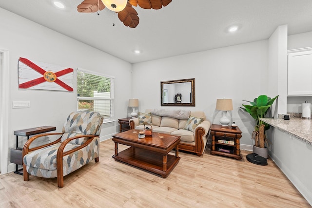 living room featuring ceiling fan and light wood-type flooring