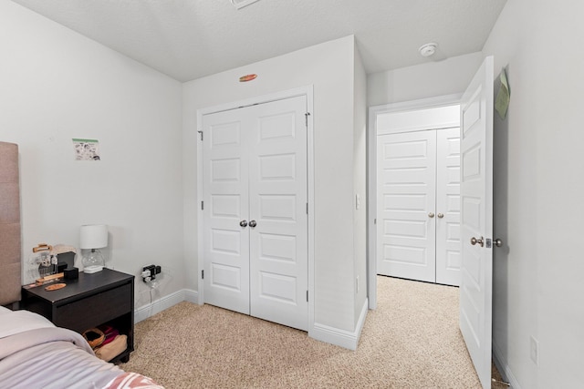 bedroom featuring light carpet and a closet