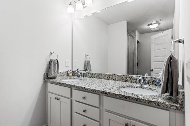 bathroom with vanity and a textured ceiling