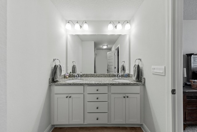 bathroom featuring vanity and a textured ceiling