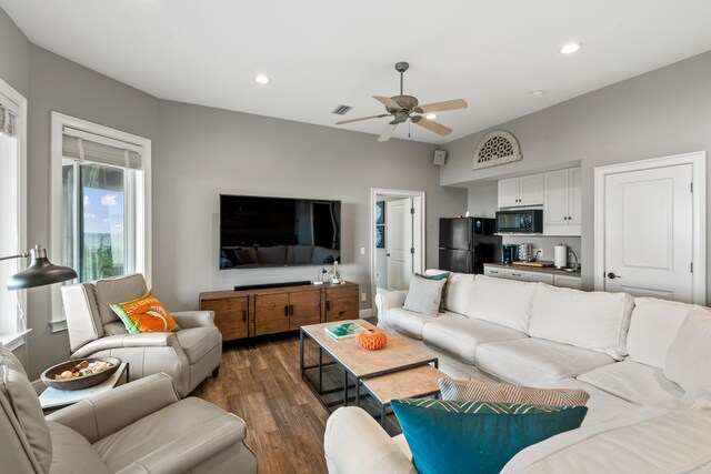 living room featuring ceiling fan and dark hardwood / wood-style flooring