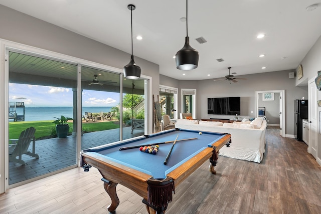 game room featuring a water view, billiards, ceiling fan, and hardwood / wood-style flooring