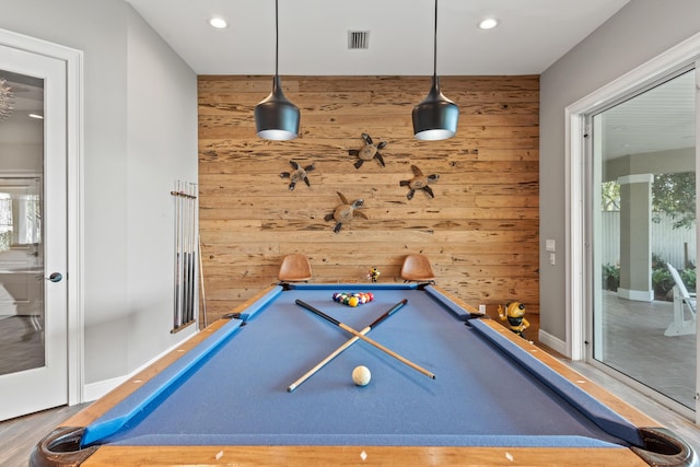 game room featuring plenty of natural light, pool table, and wooden walls