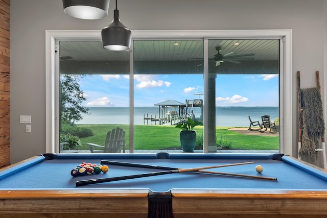 recreation room with ceiling fan, billiards, and a water view