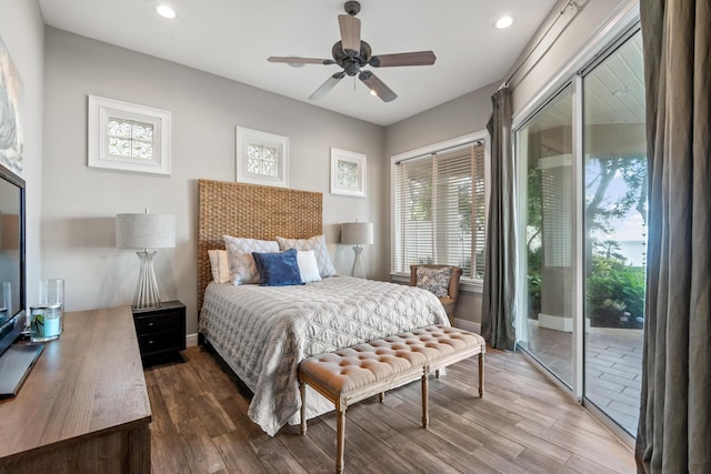 bedroom featuring ceiling fan, access to exterior, and hardwood / wood-style floors