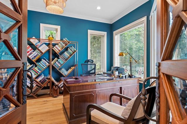 office area with light hardwood / wood-style floors and crown molding