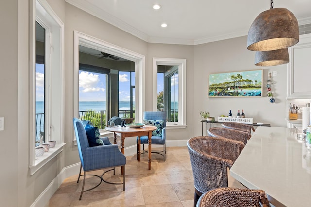 interior space with a water view and crown molding