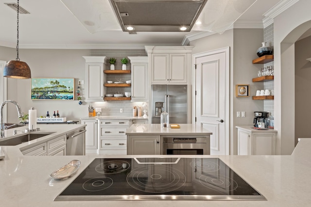 kitchen with sink, white cabinetry, appliances with stainless steel finishes, and ornamental molding