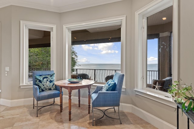 sitting room featuring plenty of natural light, crown molding, and a water view