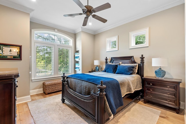 bedroom with ceiling fan, light wood-type flooring, and ornamental molding