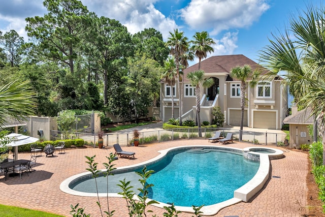 view of pool with an in ground hot tub and a patio area