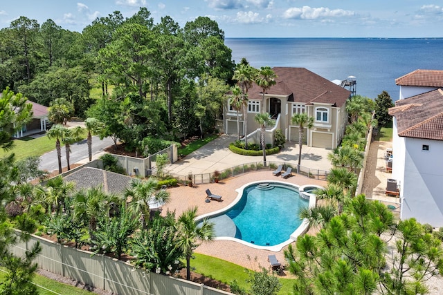 view of pool with a water view and a patio area