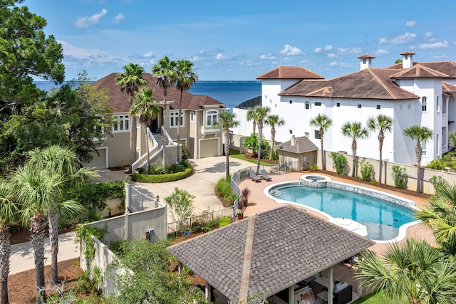 view of swimming pool with a water view and a patio