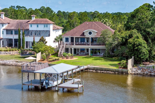 view of dock with a water view and a yard