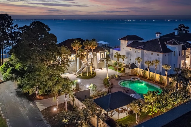 pool at dusk with a water view