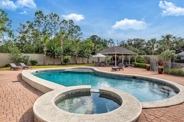 view of pool with a gazebo, an in ground hot tub, and a patio