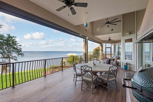 deck featuring ceiling fan and a water view