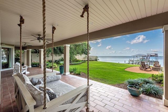 view of patio featuring a water view, an outdoor hangout area, and ceiling fan