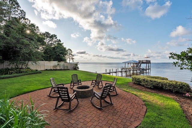 view of patio / terrace with a water view, an outdoor fire pit, and a dock